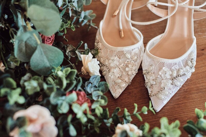 Wedding Shoes and flowers at Sunset Hills Wedding Barn in Central Lake, Michigan