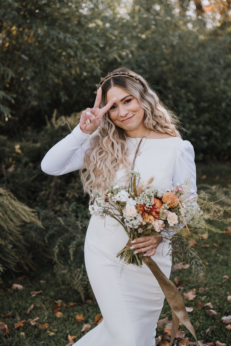Bride in long-sleeve wedding gown with neutral bouquet at modern fall wedding in Hoboken NJ