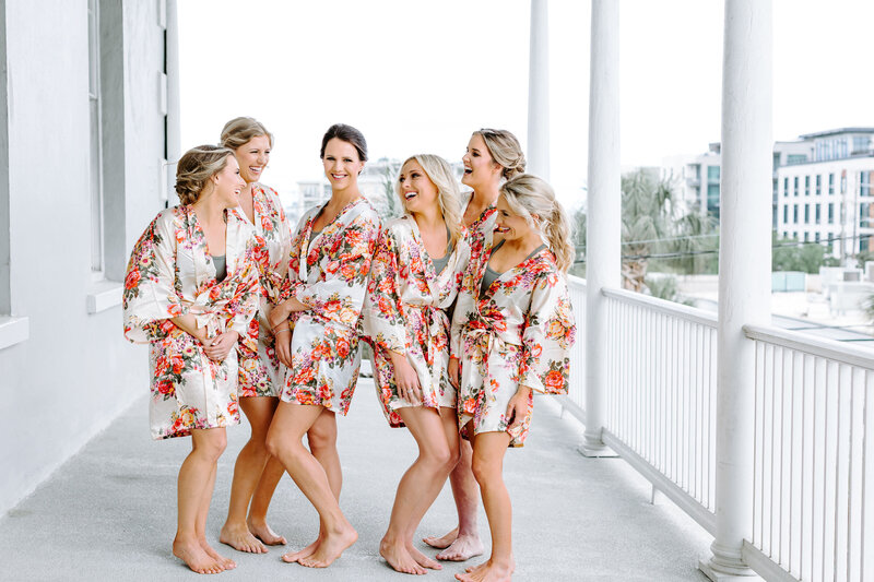 bride and bridesmaids on porch at gadsden house in matching robes