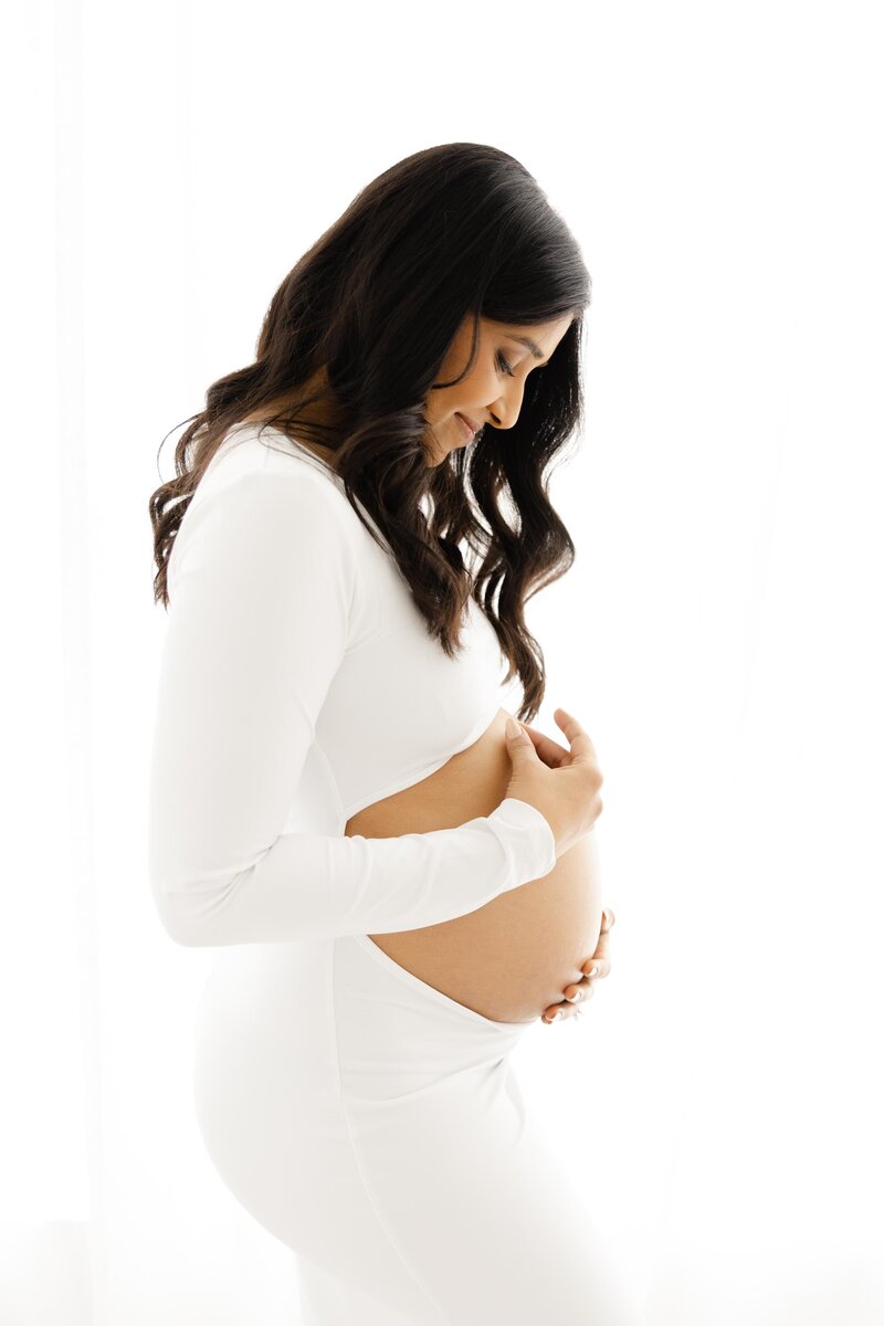 Portrait of pregnant mom touching her bare belly by Northern Virginia Maternity Photographer