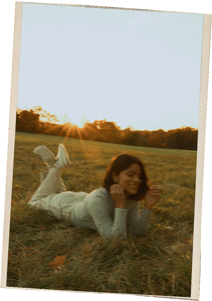 Adventurous portrait of a New York Wedding Photographer in a field at golden hour