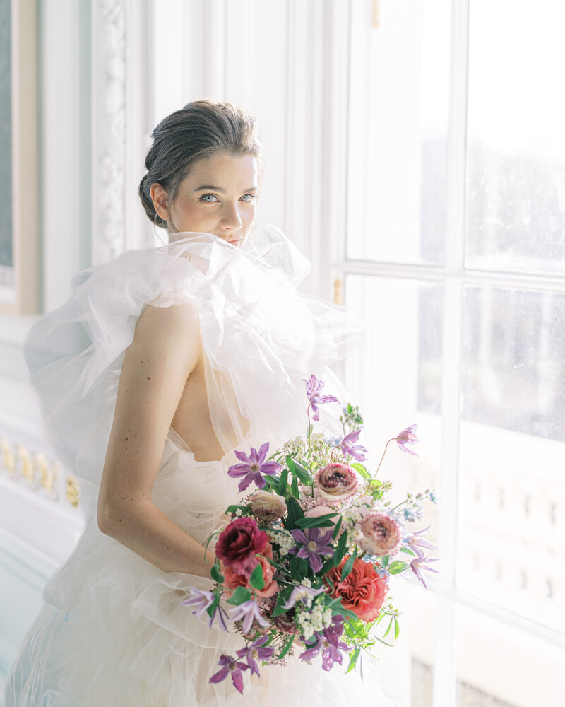 Bride in designer wedding dress with bouquet in London