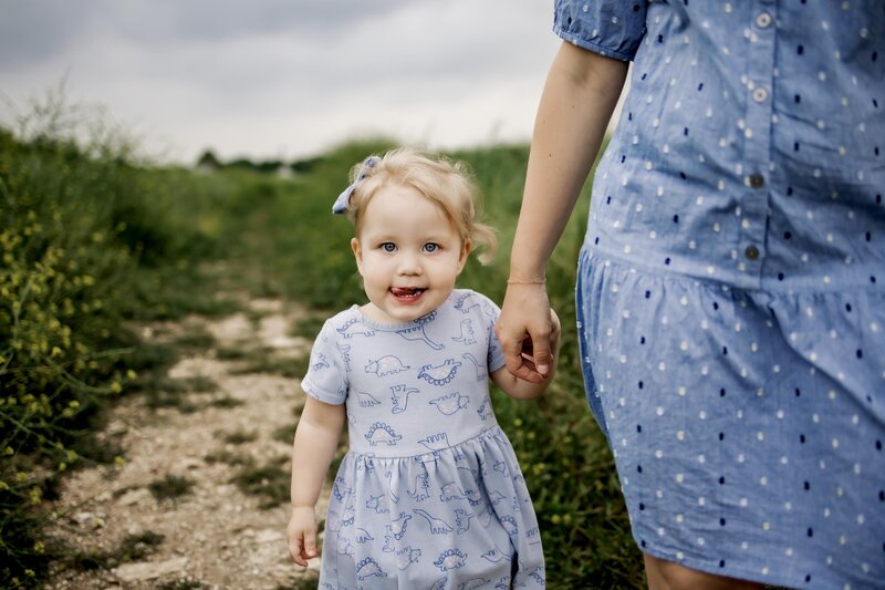 mom hold baby girl at an outdoor session in Flower Mound Texas
