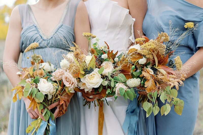 Bride with two brides maids in blue dresses