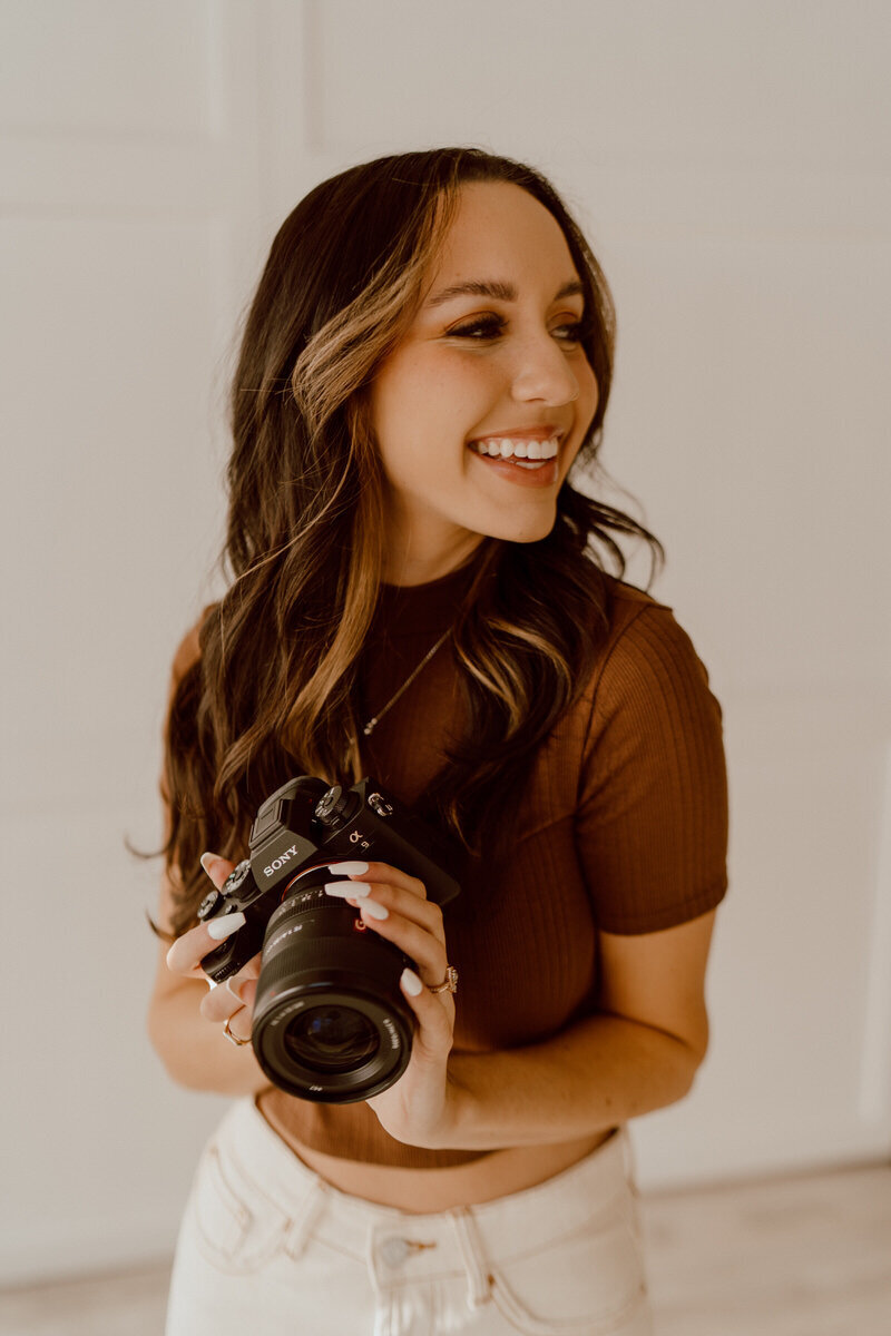 photographer smiling with a camera on her head