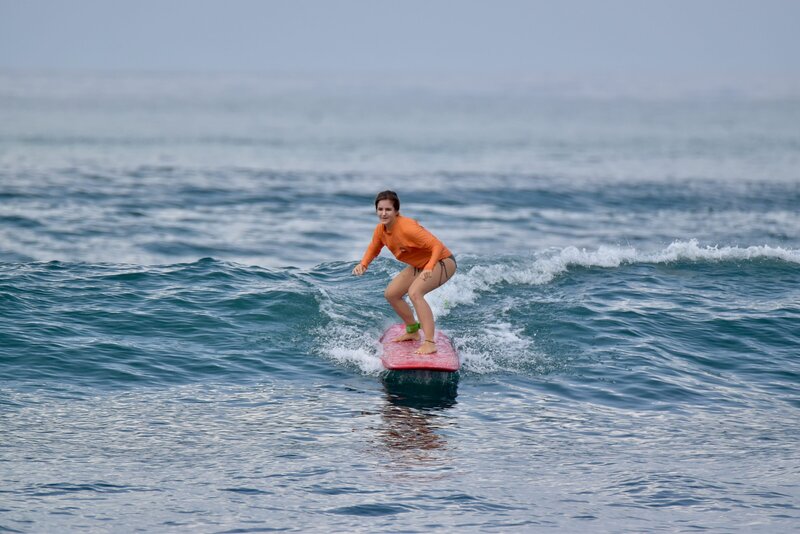 Student improving their skills on surfskates before heading into the ocean.