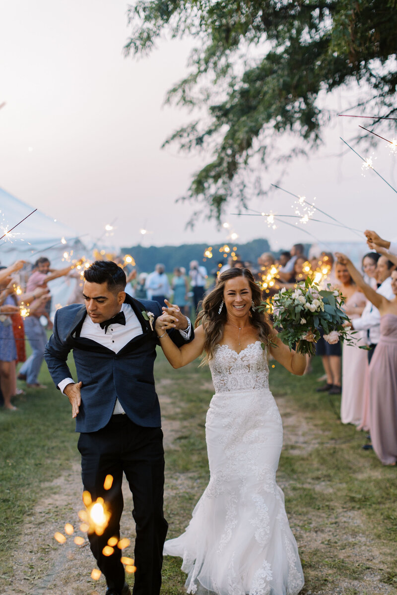 Kelly and Lee dance under a sparkler exit at their Lansing wedding, photo by Cynthia Mae Photography Lansing Wedding Photographer