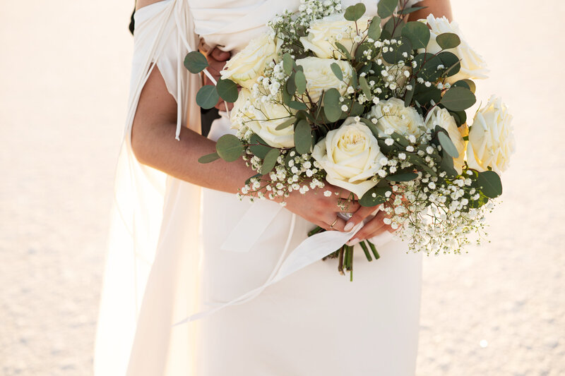 Utah Bonneville Salt Flats Elopement with bride and groom with florals