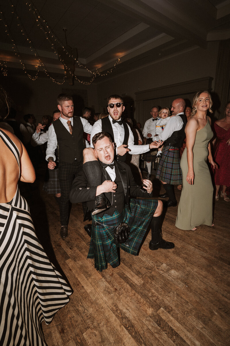 bride holding grooms face and they touch noses and look lovingly into each other eyes emotional alternative wedding photographer scotland