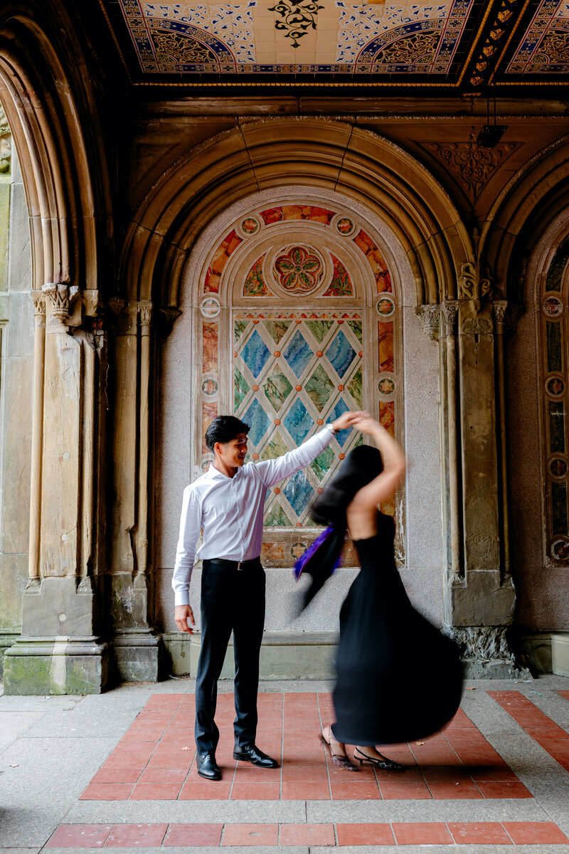 Graduate spinning around for photos with her significant other.