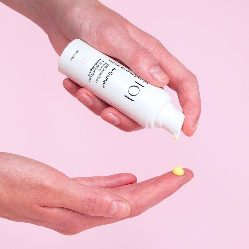 Hands holding Geek & Gorgeous A-Game 20 Retinal Serum with a small amount dispensed