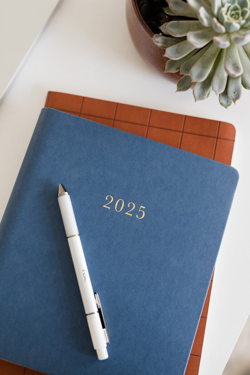 Blue journal sitting on a white desk