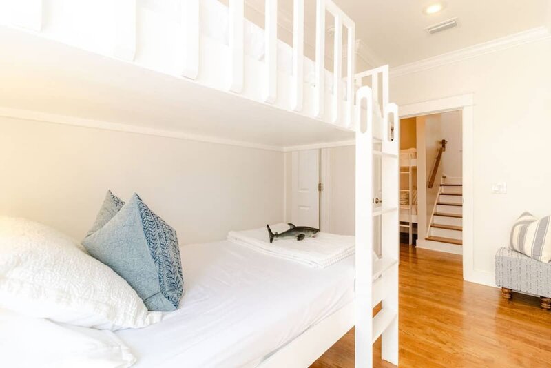 white bunk beds with blue pillow