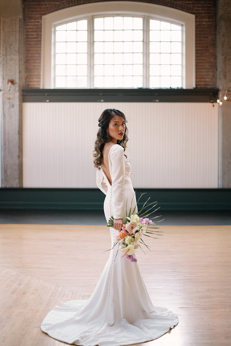 Beautiful bride holding her floral wedding bouquet