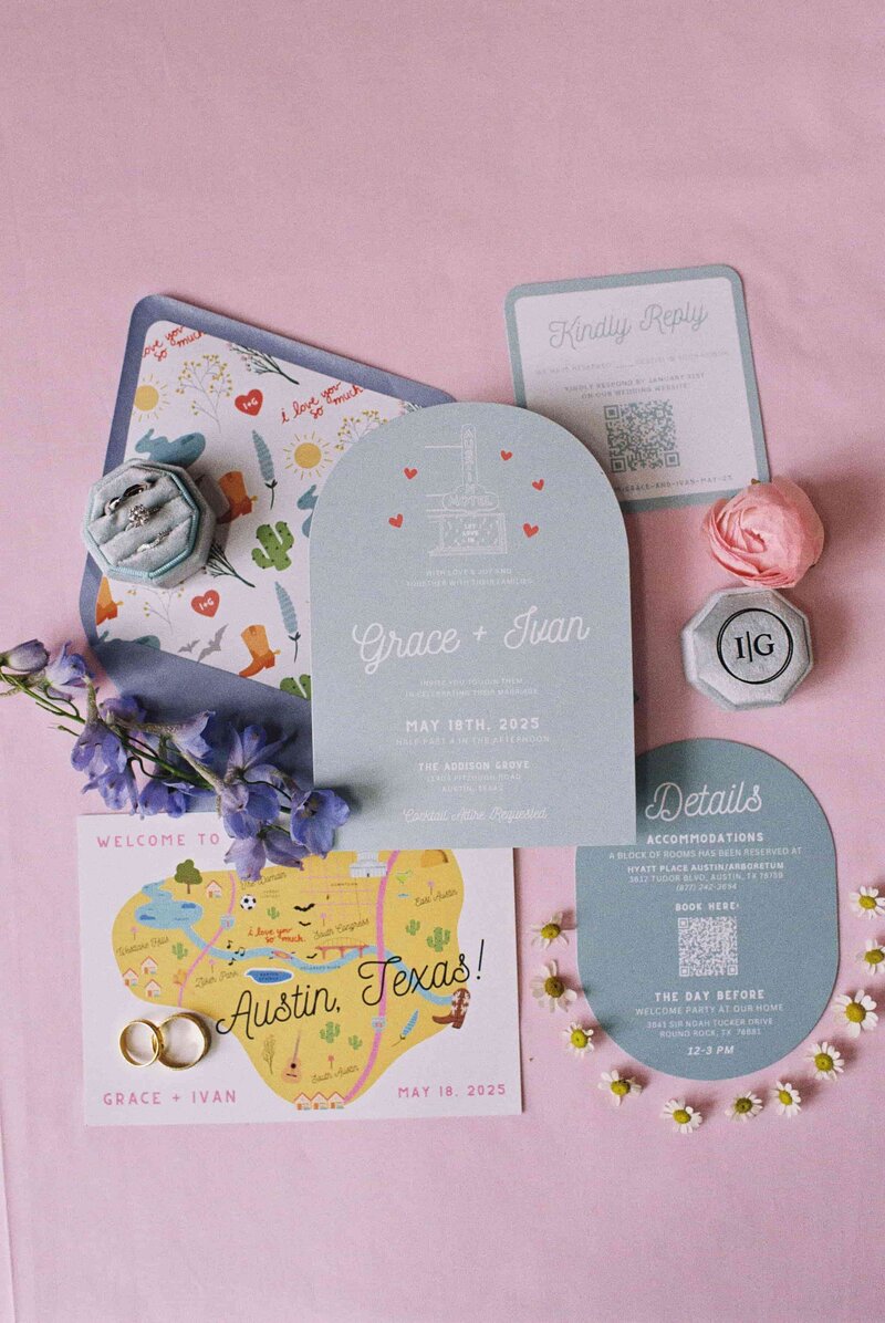 This image displays a neatly arranged wedding invitation suite for "Grace + Ivan," set against a pink background.