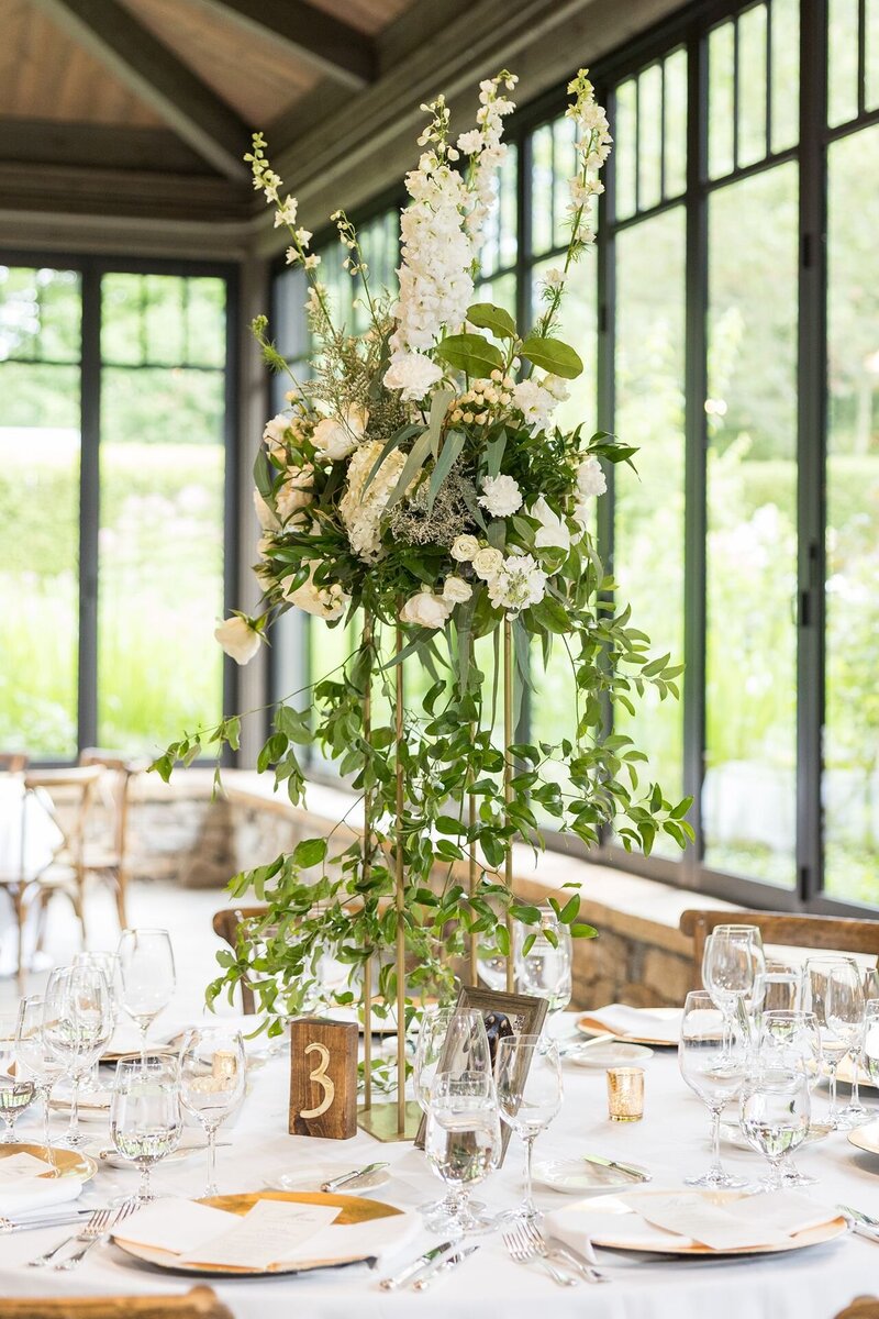 Tall white floral centerpiece at wedding reception