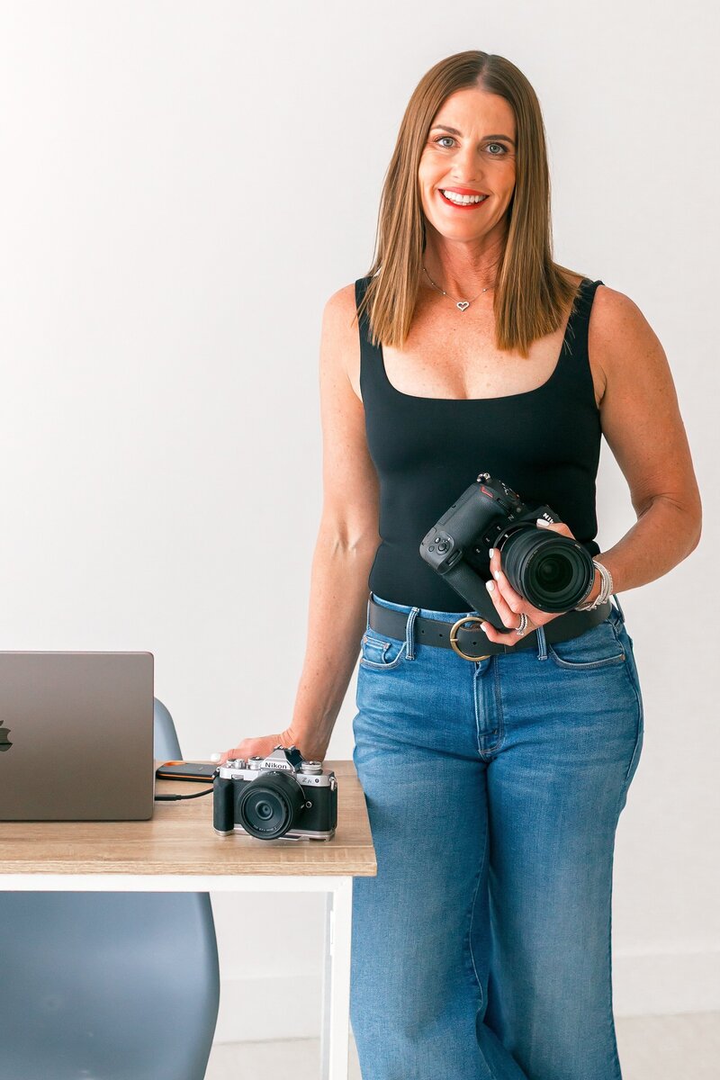 Danielle Muccillo at Danielle MuccilloPhotography posing with camera at simply studio 