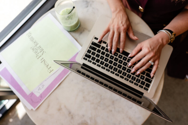 Laptop and Fresh Page Marketing brand paper on desk, symbolizing support for Shopify stores, Faire wholesale, copywriting, and small business website design.