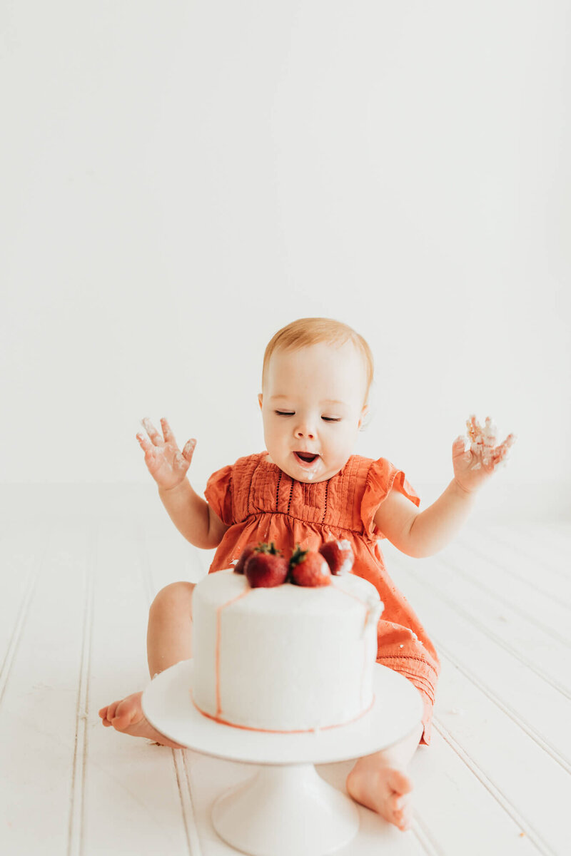 family loves on baby brother in a field family session.