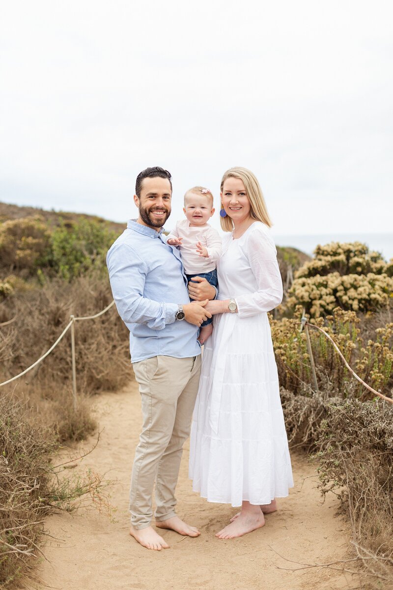 family poses for a portrait at Pointe Dume