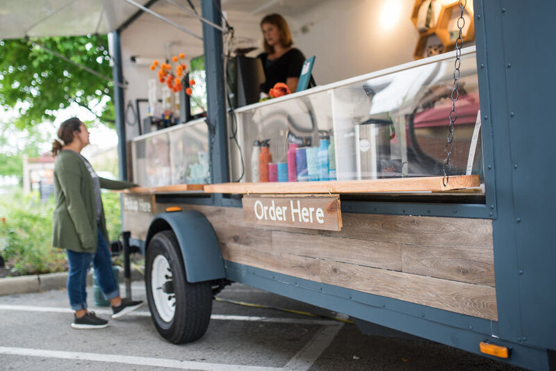 Rachel serving a customer at a mobile espresso bar