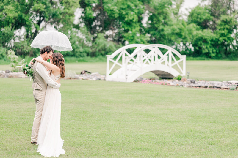 Maple Dell Acres Rainy Wedding Day Portraits in front of white bridge