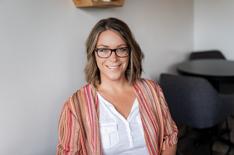 jen heller in a striped shirt smiling