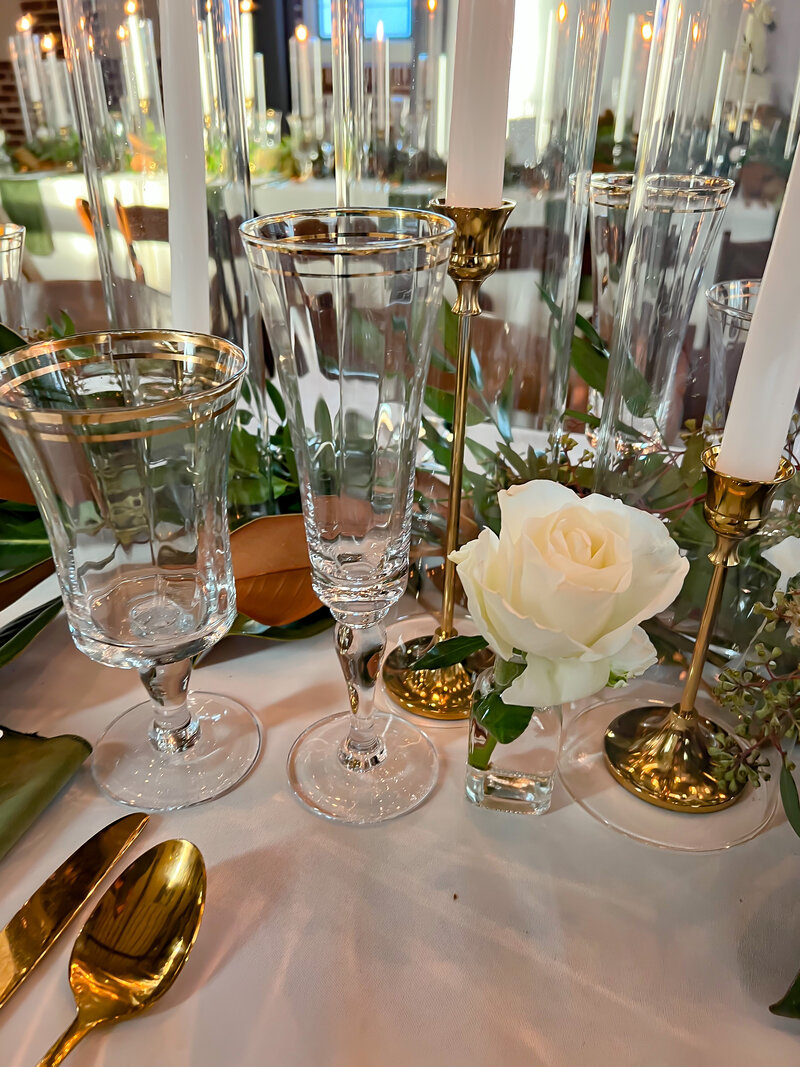Wedding table design with gold rim glassware and gold candlesticks