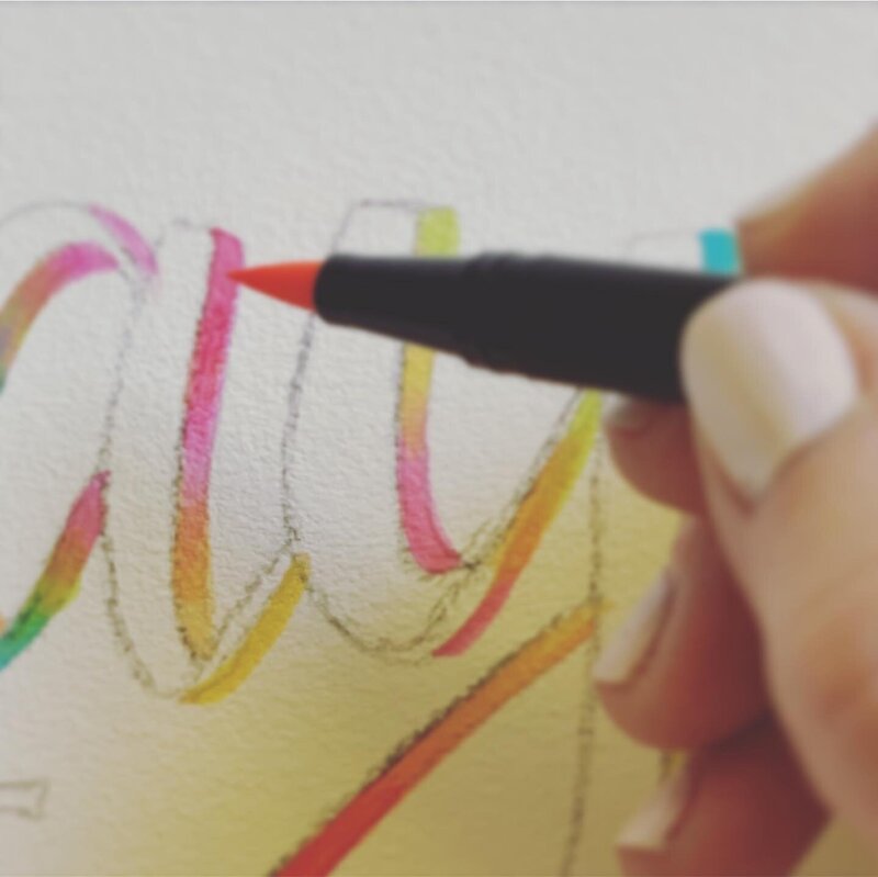 Watercolor hand lettering on white paper