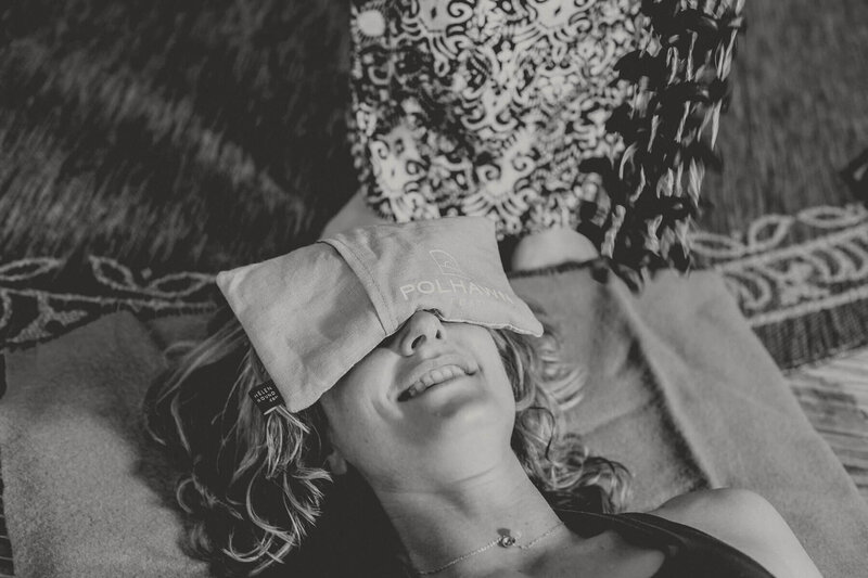 a lady lying down  with her eyes covered