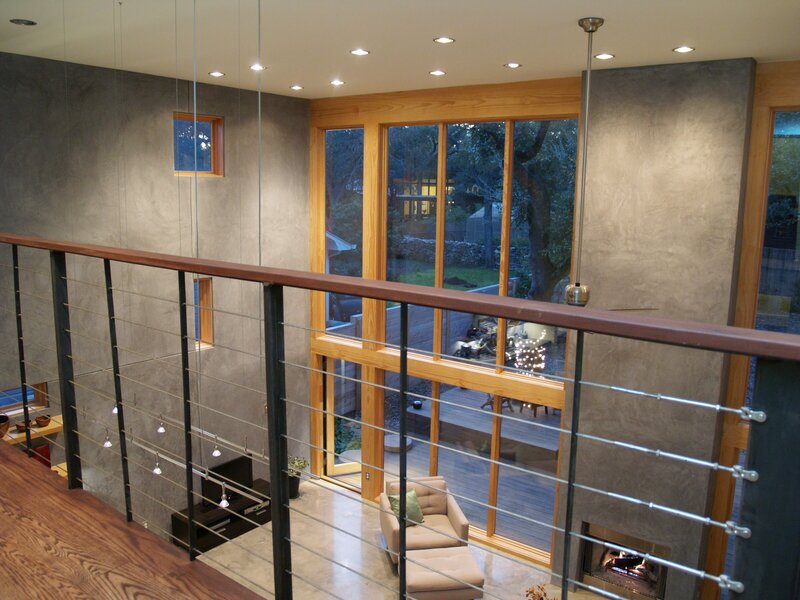 custom loft in modern home in austin, texas. concrete walls, wood accent wall.