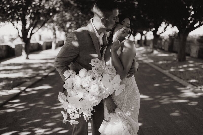 Couple Embracing in Tree Lined Estate Drive - Leeann & Carlin | Abeja Winery & Inn Intimate Wedding Walla Walla Washington