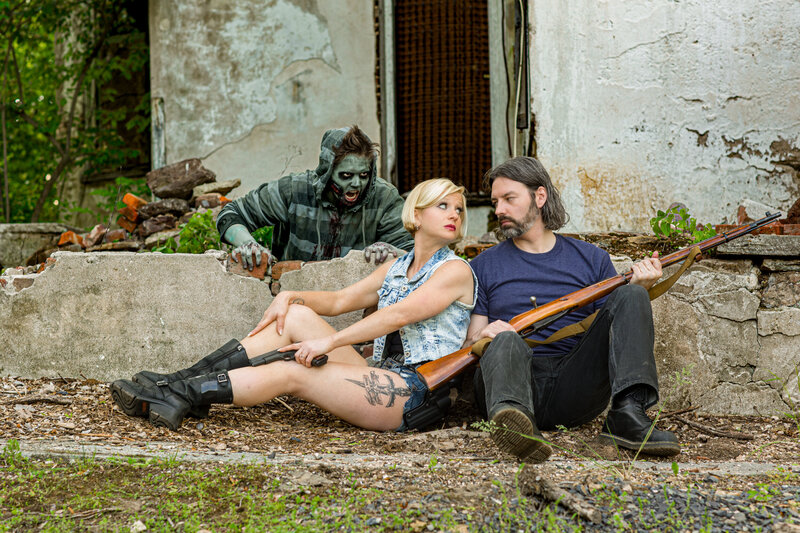 A creative and fun engagement session with a Walking Dead zombie-hunting theme, featuring the couple decked out for an adventurous, apocalyptic vibe.