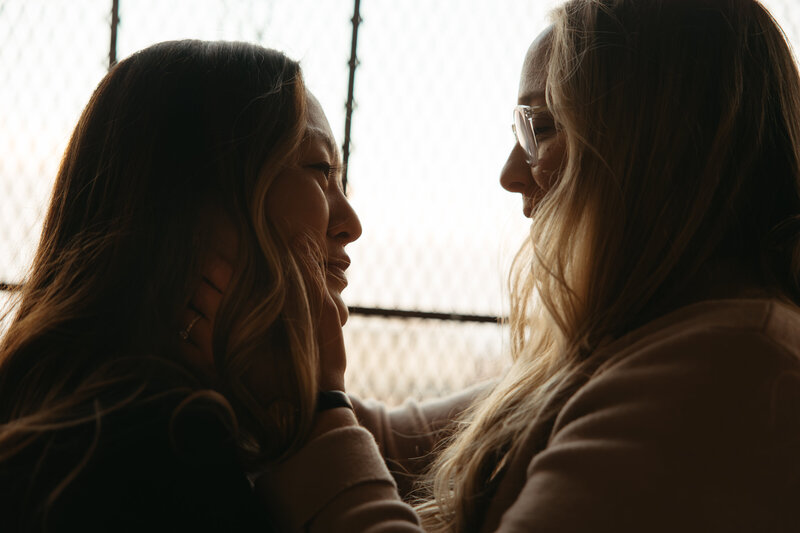 lesbian couple holds each other