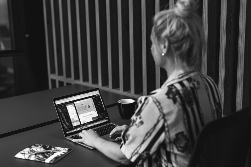Brand & Website Designer and founder of Sparkle Creative Studio designing a website on her laptop