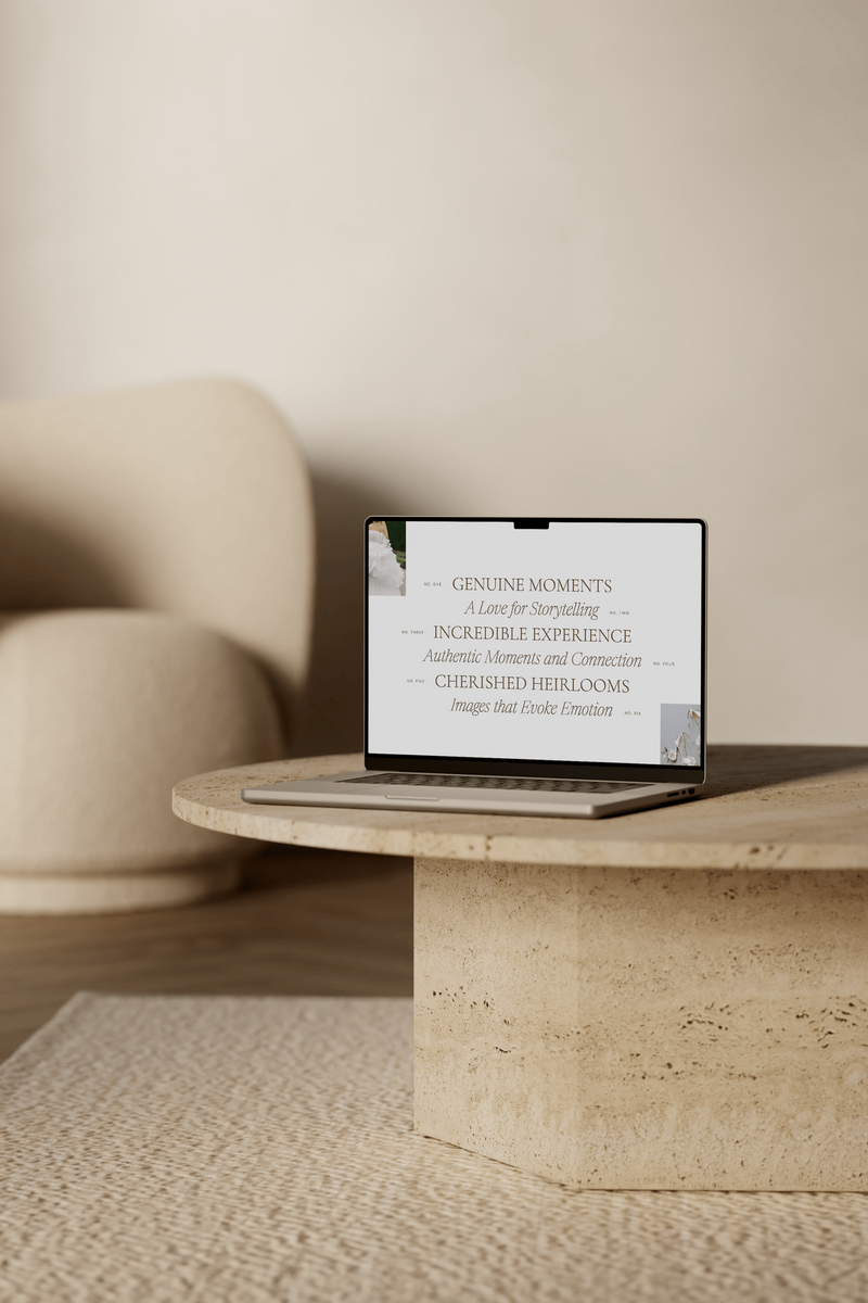 A laptop sitting open on a stone coffee table