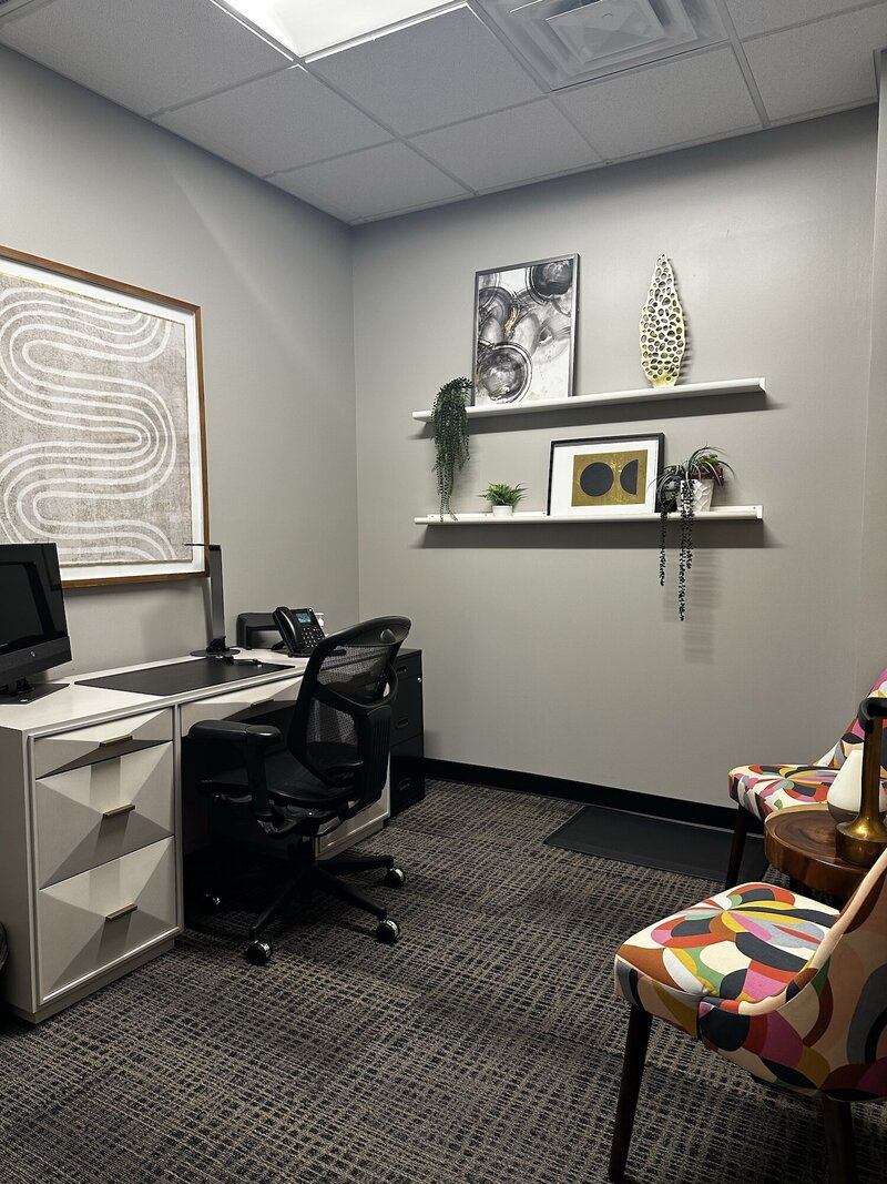 Modern funky white desk next to a plant