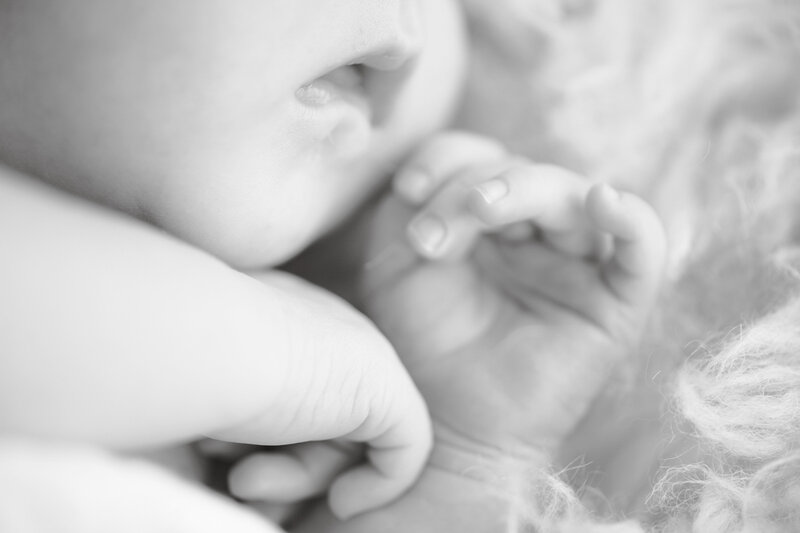 close up photo of newborn baby's lips and hands at family photography studio in Boise