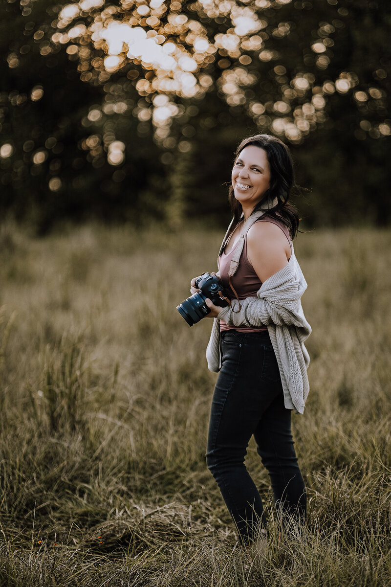 photographer headshot in a field at sunset