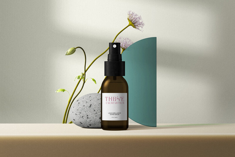 cosmetic-bottle-mockups-with-flowers-and-green-glass-front-view copy