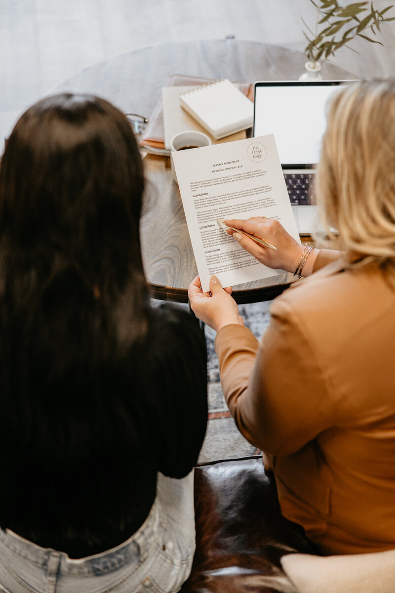 Intellectual property lawyers review a contract with a small business owner
