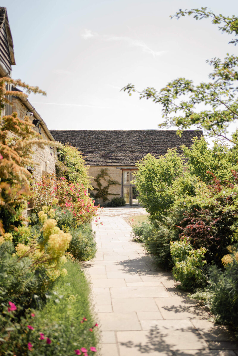 Lush summer gardens outside Caswell House, a Cotswold wedding venue