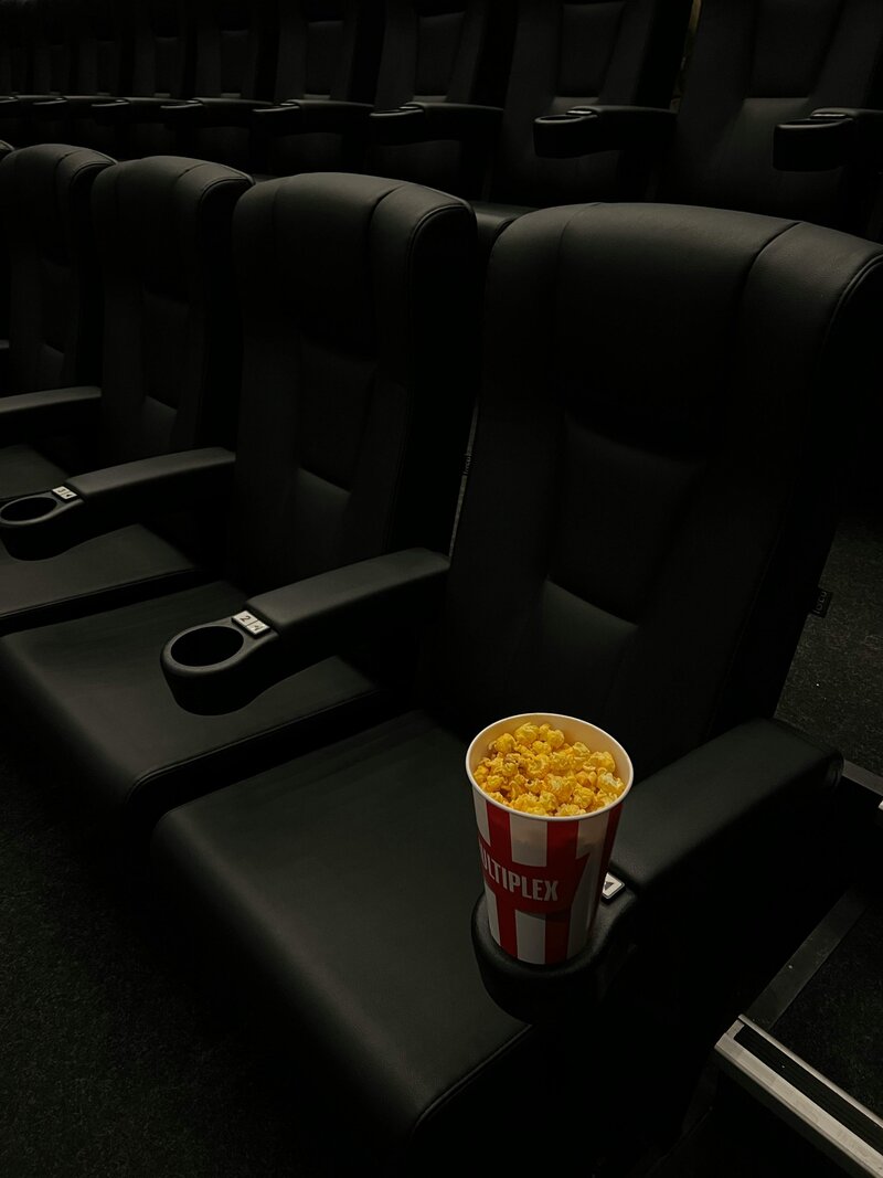 Black movie theater chairs with popcorn