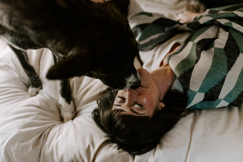 Woman lying down being kissed on the nose by dpg