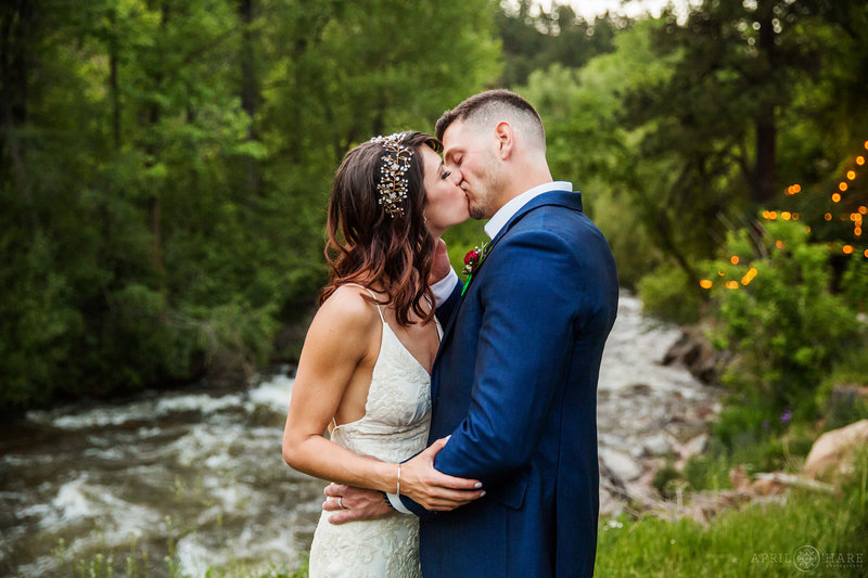 Romantic wedding portrait next to mountain stream at Boulder Creek Wedgewood Weddings During June
