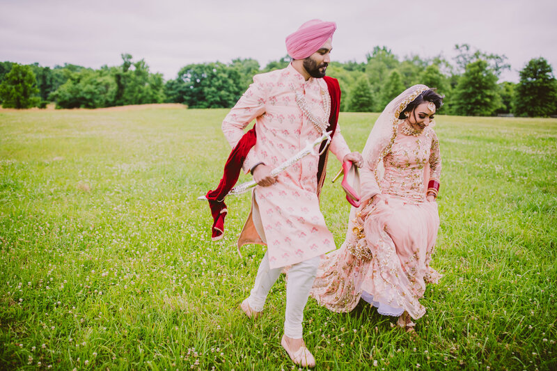 A bride and groom running during their sikh wedding in nj