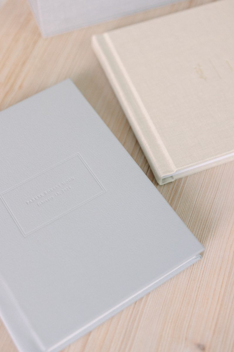 Luxury flat lay of heirloom photography album designed for new parents.