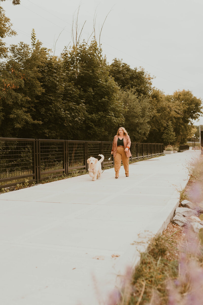 Vermont wedding planner walking her dog downtown river front photo courtesy of Kelcie Janelle