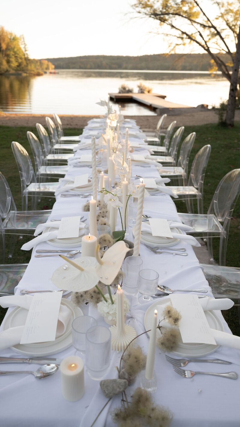 Intimate wedding dinner table with minimal menu design and romantic candles