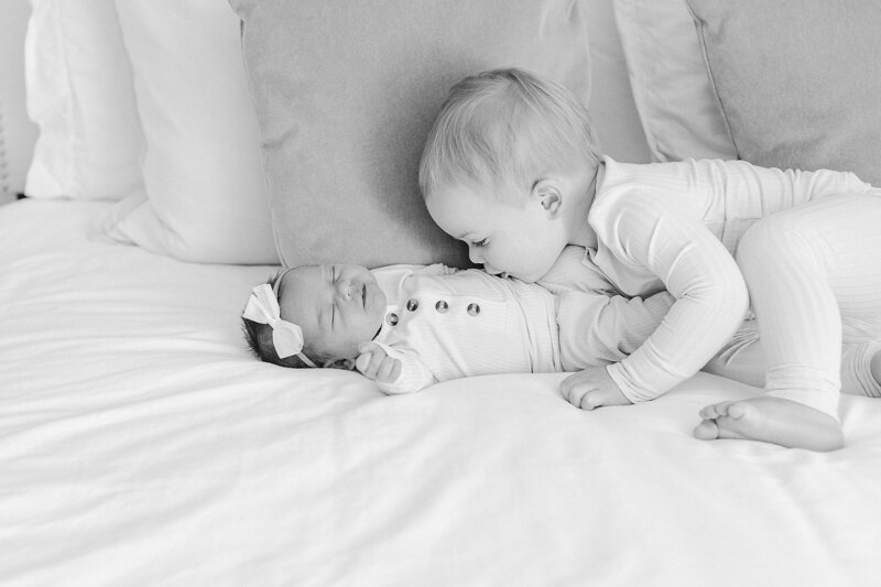 Big brother kissing baby sister during a newborn session